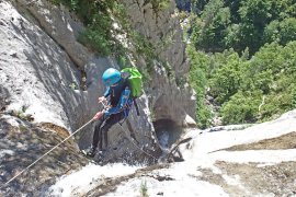 Equipée de son harnais, Amélie commence une jolie descente en rappel - Canyoning en Pyrénées - Espagne